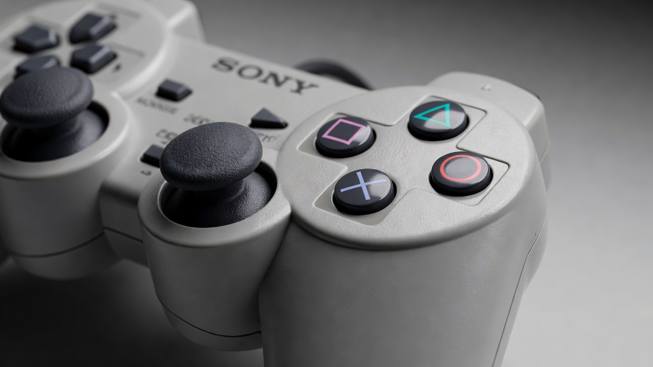 Detailed close-up of classic grey PlayStation console controller and buttons